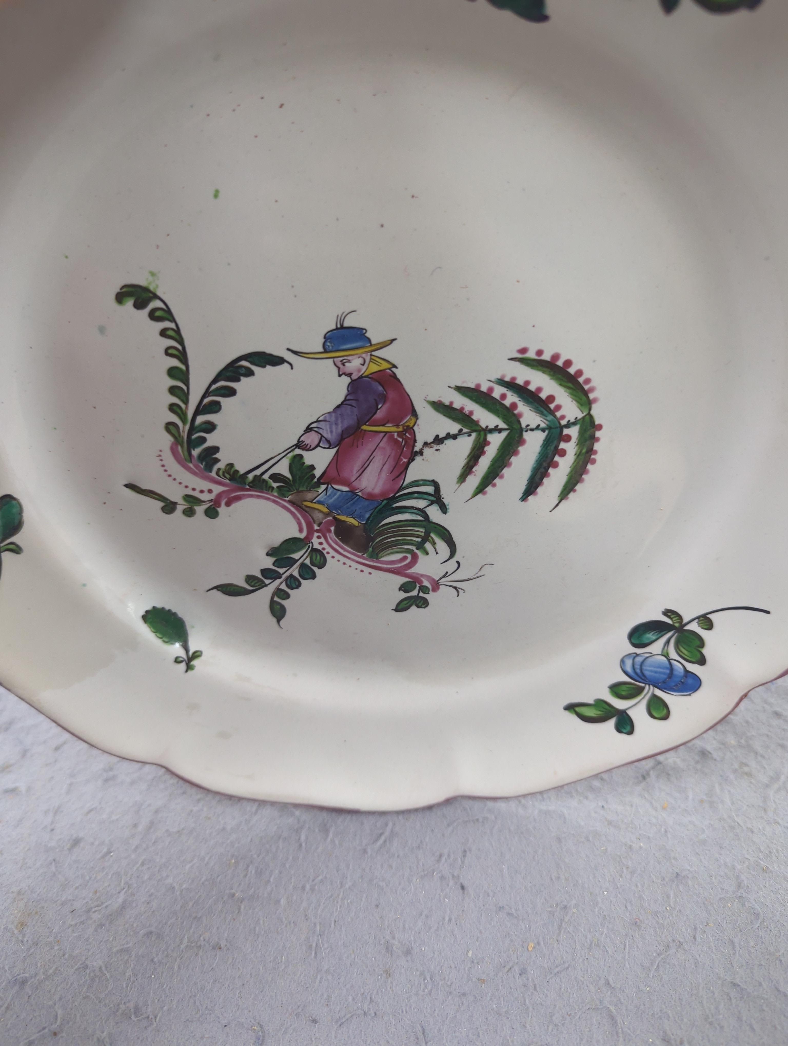 An 18th century Delft plate and three 19th century faience plates, largest 26cm diameter (4)